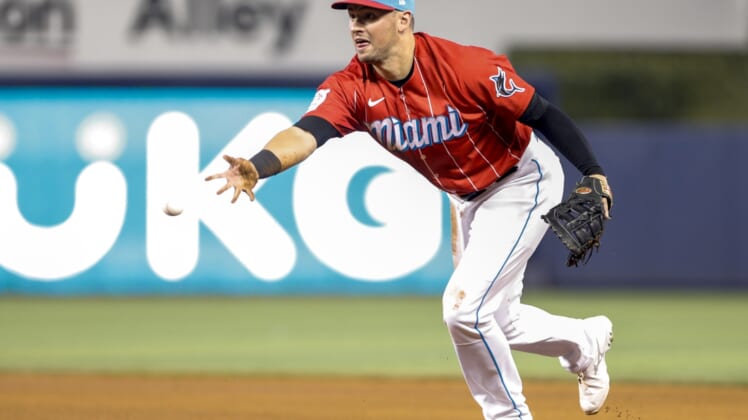 Sep 5, 2021; Miami, Florida, USA; Miami Marlins first baseman Joe Panik (12) throws to first base for the out against Philadelphia Phillies third baseman Brad Miller (not pictured) during the fourth inning at loanDepot Park. Mandatory Credit: Sam Navarro-USA TODAY Sports