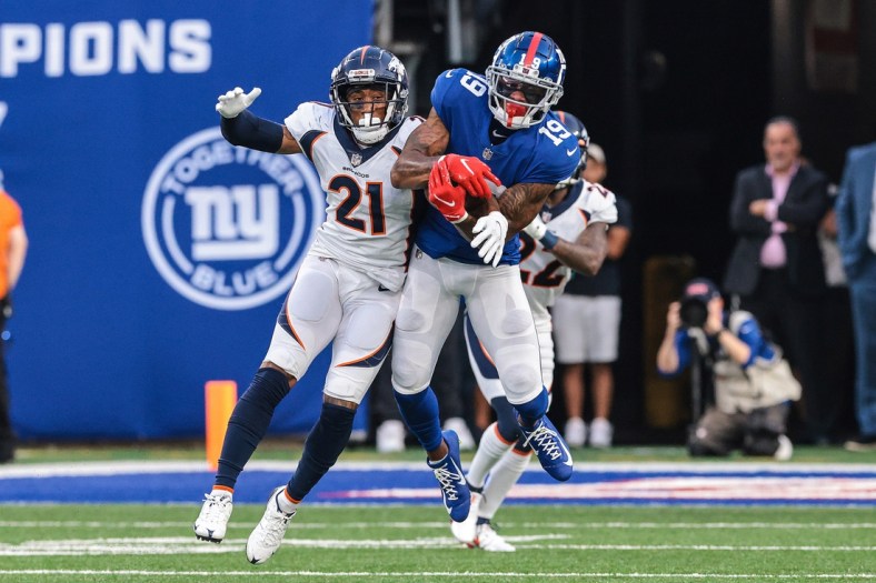 Sep 12, 2021; East Rutherford, New Jersey, USA; New York Giants wide receiver Kenny Golladay (19) catches the ball over Denver Broncos cornerback Ronald Darby (21) during the second half at MetLife Stadium. Mandatory Credit: Vincent Carchietta-USA TODAY Sports