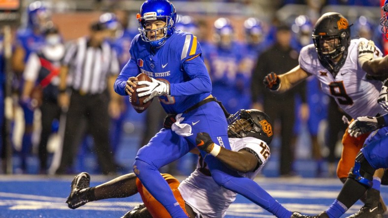 Sep 18, 2021; Boise, Idaho, USA; Boise State Broncos quarterback Hank Bachmeier (19) is sacked by Oklahoma State Cowboys defensive tackle Jayden Jernigan (42) during the second half at Albertsons Stadium. Oklahoma State won 21-20. Mandatory Credit: Brian Losness-USA TODAY Sports