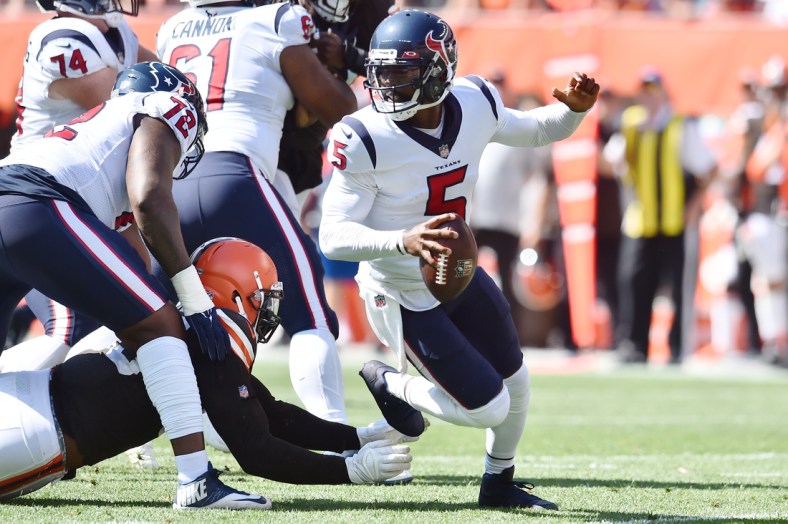 Sep 19, 2021; Cleveland, Ohio, USA; Houston Texans quarterback Tyrod Taylor (5) scrambles from the Cleveland Browns defense during the first half at FirstEnergy Stadium. Mandatory Credit: Ken Blaze-USA TODAY Sports