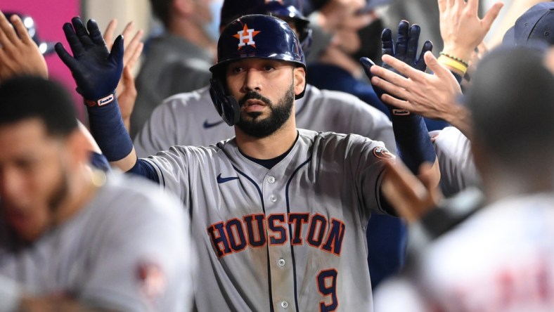 Sep 20, 2021; Anaheim, California, USA; Houston Astros second baseman Marwin Gonzalez (9) is congratulated in the dugout after hitting a grand slam home run against the Los Angeles Angels in the ninth inning at Angel Stadium. Mandatory Credit: Jayne Kamin-Oncea-USA TODAY Sports