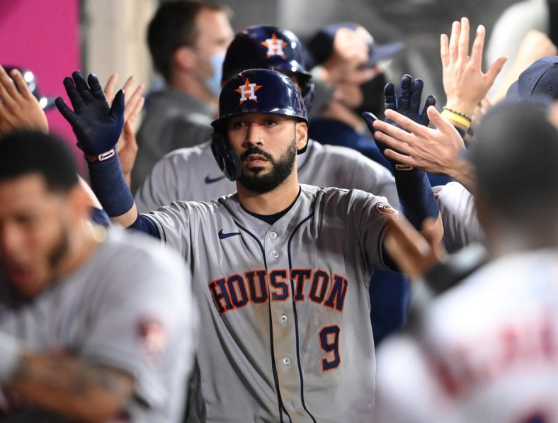 Sep 20, 2021; Anaheim, California, USA; Houston Astros second baseman Marwin Gonzalez (9) is congratulated in the dugout after hitting a grand slam home run against the Los Angeles Angels in the ninth inning at Angel Stadium. Mandatory Credit: Jayne Kamin-Oncea-USA TODAY Sports