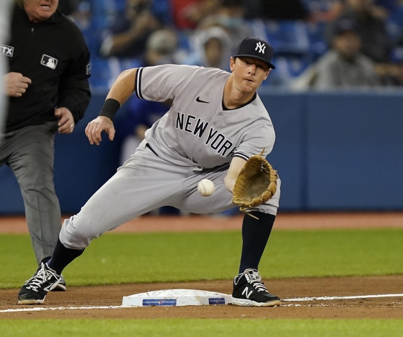 Sep 28, 2021; Toronto, Ontario, CAN; New York Yankees third baseman DJ LeMahieu (26) makes a catch before getting Toronto Blue Jays shortstop Bo Bichette (not pictured) out trying to steal during the sixth inning at Rogers Centre. Mandatory Credit: John E. Sokolowski-USA TODAY Sports