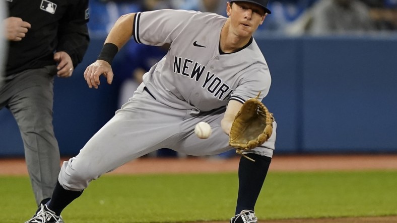 Sep 28, 2021; Toronto, Ontario, CAN; New York Yankees third baseman DJ LeMahieu (26) makes a catch before getting Toronto Blue Jays shortstop Bo Bichette (not pictured) out trying to steal during the sixth inning at Rogers Centre. Mandatory Credit: John E. Sokolowski-USA TODAY Sports