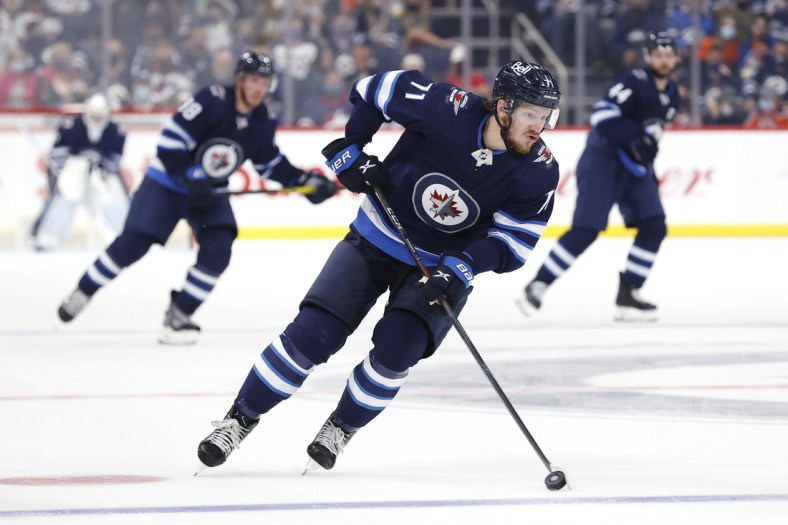 Sep 29, 2021; Winnipeg, Manitoba, CAN;  Winnipeg Jets right wing Evgeny Svechnikov (71) skates up the ice against the Edmonton Oilers in the second period at Canada Life Centre. Mandatory Credit: James Carey Lauder-USA TODAY Sports