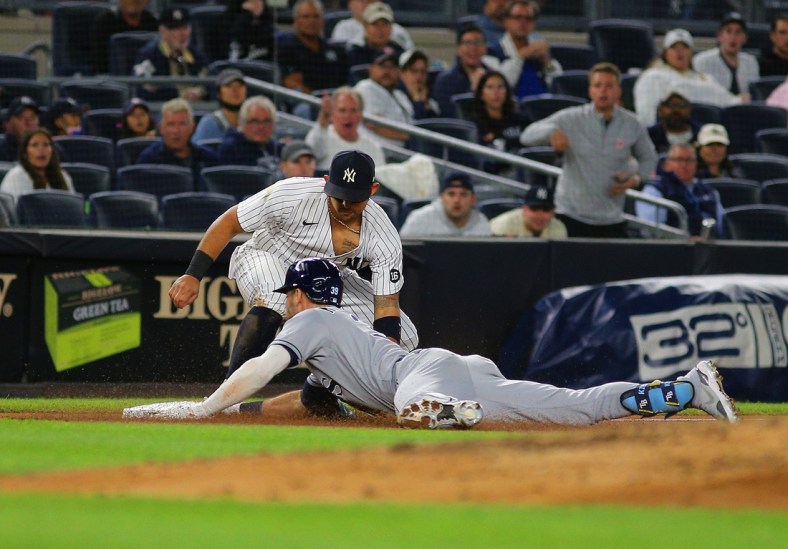Oct 1, 2021; Bronx, New York, USA; Tampa Bay Rays center fielder Kevin Kiermaier (39) slides safely into third base with a triple against the New York Yankees during the fifth inning at Yankee Stadium. Mandatory Credit: Andy Marlin-USA TODAY Sports
