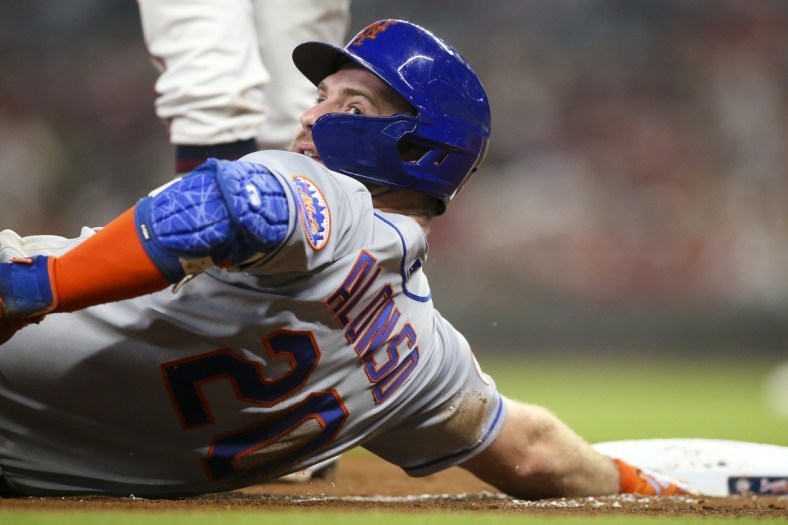 Oct 1, 2021; Atlanta, Georgia, USA; New York Mets first baseman Pete Alonso (20) reacts after sliding safely into third past the tag of Atlanta Braves third baseman Ehire Adrianza (not pictured) in the fourth inning at Truist Park. Mandatory Credit: Brett Davis-USA TODAY Sports