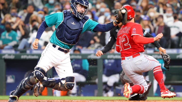 Oct 1, 2021; Seattle, Washington, USA;  Los Angeles Angels second baseman David Fletcher (22) beats the tag by Seattle Mariners catcher Tom Murphy (2) to score and take a 2-1 lead during the third inning at T-Mobile Park. Mandatory Credit: Abbie Parr-USA TODAY Sports