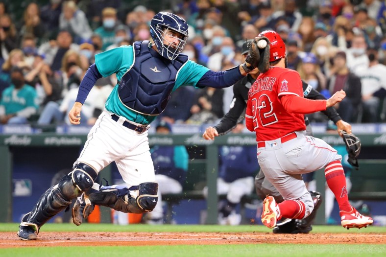 Oct 1, 2021; Seattle, Washington, USA;  Los Angeles Angels second baseman David Fletcher (22) beats the tag by Seattle Mariners catcher Tom Murphy (2) to score and take a 2-1 lead during the third inning at T-Mobile Park. Mandatory Credit: Abbie Parr-USA TODAY Sports