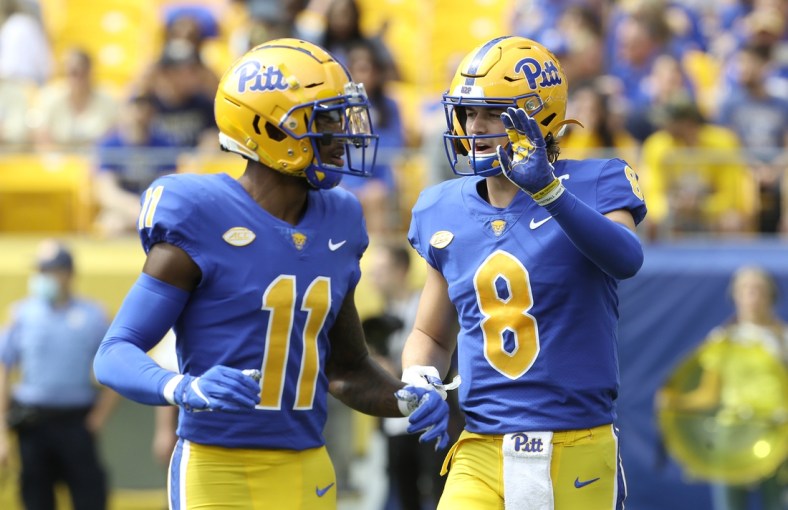 Sep 25, 2021; Pittsburgh, Pennsylvania, USA;  Pittsburgh Panthers wide receiver Taysir Mack (11) and quarterback Kenny Pickett (8) talk before a play against the New Hampshire Wildcats during the second quarter at Heinz Field. Mandatory Credit: Charles LeClaire-USA TODAY Sports