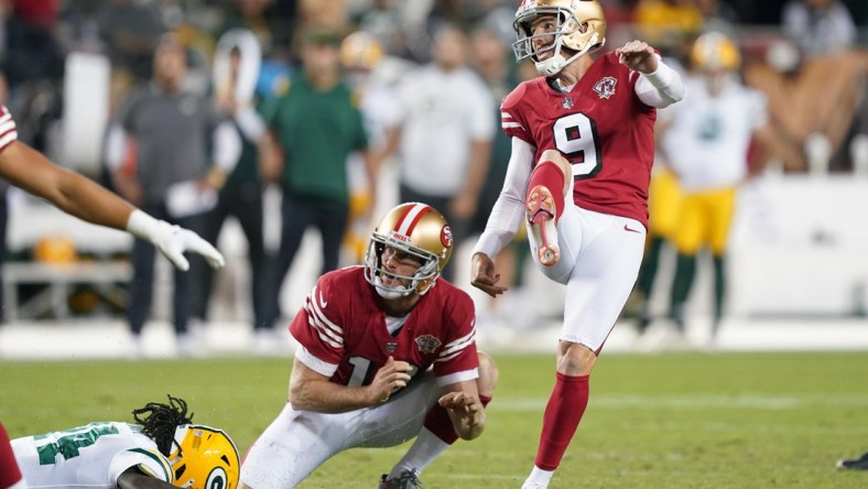 Sep 26, 2021; Santa Clara, California, USA; San Francisco 49ers kicker Robbie Gould (9) kicks an extra point as punter Mitch Wishnowsky (18) holds during the fourth quarter against the Green Bay Packers at Levi's Stadium. Mandatory Credit: Darren Yamashita-USA TODAY Sports