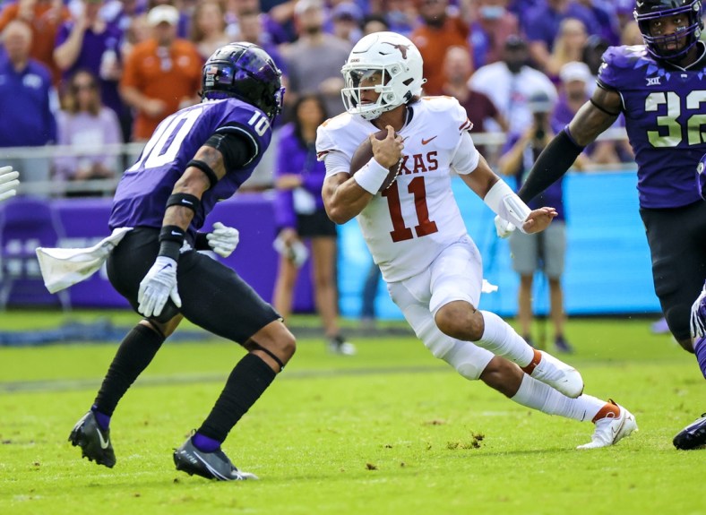 Oct 2, 2021; Fort Worth, Texas, USA; Texas Longhorns quarterback Casey Thompson (11) runs with the ball as TCU Horned Frogs safety Da'Veawn Armstead (10) defends during the first quarter at Amon G. Carter Stadium. Mandatory Credit: Kevin Jairaj-USA TODAY Sports