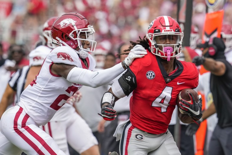 Oct 2, 2021; Athens, Georgia, USA; Georgia Bulldogs running back James Cook (4) gets knocked out of bounds by Arkansas Razorbacks defensive back Montaric Brown (21) during the first quarter at Sanford Stadium. Mandatory Credit: Dale Zanine-USA TODAY Sports