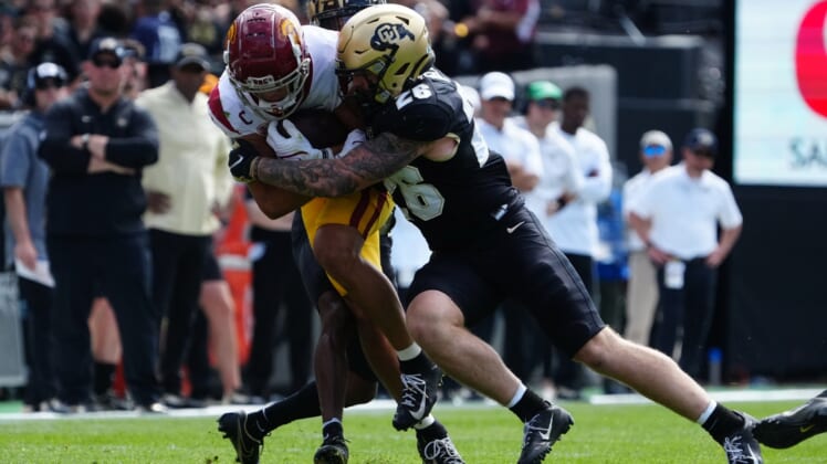 Oct 2, 2021; Boulder, Colorado, USA; Colorado Buffaloes linebacker Carson Wells (26) tackles USC Trojans wide receiver Drake London (15) in the second quarter at Folsom Field. Mandatory Credit: Ron Chenoy-USA TODAY Sports