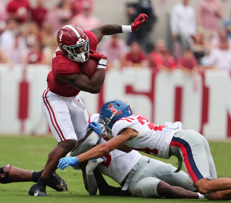 Oct 2, 2021; Tuscaloosa, Alabama, USA; Alabama Crimson Tide running back Brian Robinson Jr. (4) carries the ball against the Mississippi Rebels during the first half of an NCAA college football game at Bryant-Denny Stadium. Mandatory Credit: Butch Dill-USA TODAY Sports
