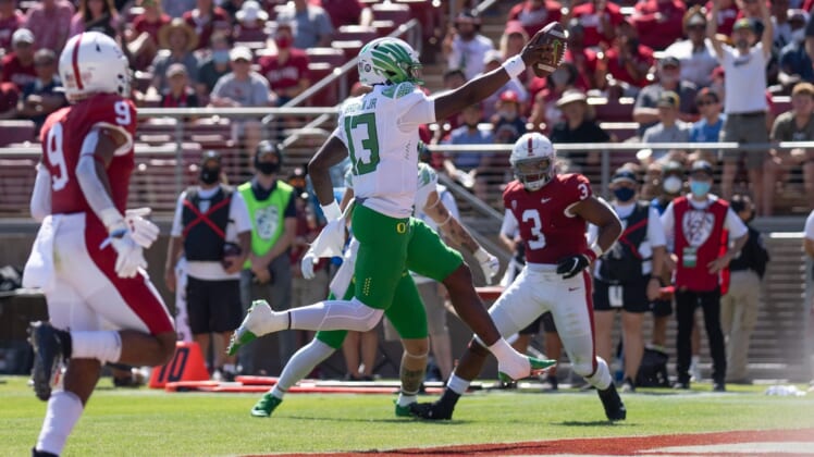 Oct 2, 2021; Stanford, California, USA;  Oregon Ducks quarterback Anthony Brown (13) scores during the second quarter against the Stanford Cardinal at Stanford Stadium. Mandatory Credit: Stan Szeto-USA TODAY Sports