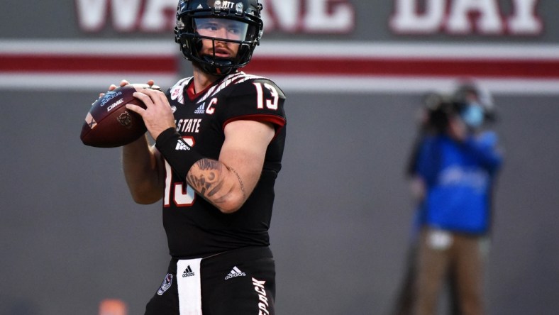 Oct 2, 2021; Raleigh, North Carolina, USA; North Carolina State Wolfpack quarterback Devin Leary (13) drops back to pass against the Louisiana Tech Bulldogs during the first half at Carter-Finley Stadium. Mandatory Credit: Rob Kinnan-USA TODAY Sports