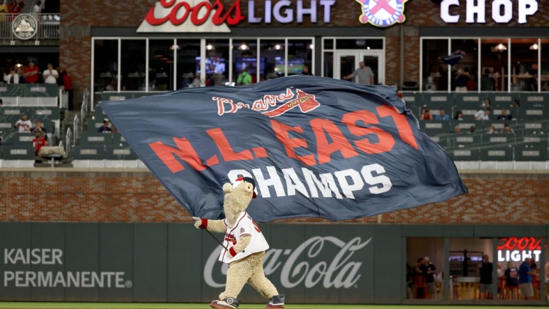 Oct 2, 2021; Atlanta, Georgia, USA; Atlanta Braves mascot Blooper waves the N.L. East Champs flag after the Atlanta Braves defeated the New York Mets at Truist Park. Mandatory Credit: Jason Getz-USA TODAY Sports