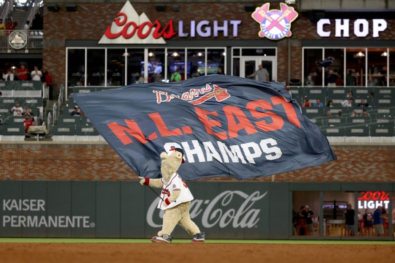 Oct 2, 2021; Atlanta, Georgia, USA; Atlanta Braves mascot Blooper waves the N.L. East Champs flag after the Atlanta Braves defeated the New York Mets at Truist Park. Mandatory Credit: Jason Getz-USA TODAY Sports