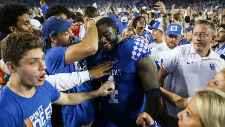 Kentucky's Joshua Paschal gets mobbed by fans after the Wildcats upset No. 10 Florida 20-13 at Kroger Field in Lexington. Paschal blocked a field goal in the second half which linebacker Trevin Wallace returned for a touchdown that sparked the Cats. Oct. 2, 2021

Kentucky Vs Florida October 2021