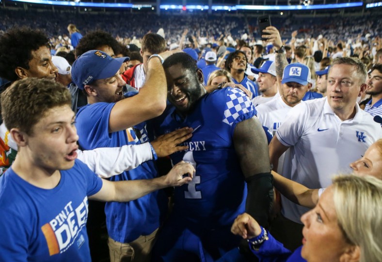 Kentucky's Joshua Paschal gets mobbed by fans after the Wildcats upset No. 10 Florida 20-13 at Kroger Field in Lexington. Paschal blocked a field goal in the second half which linebacker Trevin Wallace returned for a touchdown that sparked the Cats. Oct. 2, 2021

Kentucky Vs Florida October 2021