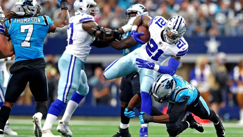 Oct 3, 2021; Arlington, Texas, USA; Dallas Cowboys running back Ezekiel Elliott (21) runs the ball against Carolina Panthers defensive end Brian Burns (53) during the first quarter at AT&T Stadium. Mandatory Credit: Mark J. Rebilas-USA TODAY Sports