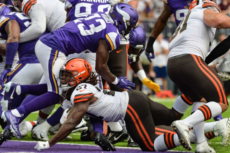 Oct 3, 2021; Minneapolis, Minnesota, USA; Cleveland Browns running back Kareem Hunt (27) reaches for the endzone to score a touchdown as Minnesota Vikings free safety Xavier Woods (23) defends during the second quarter at U.S. Bank Stadium. Mandatory Credit: Jeffrey Becker-USA TODAY Sports