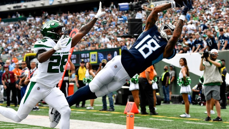 Oct 3, 2021; East Rutherford, NJ, USA;   Tennessee Titans wide receiver Josh Reynolds (18) pulls in a catch against New York Jets cornerback Brandin Echols (26) that was ruled out of bounds during the first quarter at MetLife Stadium Sunday, Oct. 3, 2021 in East Rutherford, N.J. Mandatory Credit: George Walker IV-USA TODAY Sports