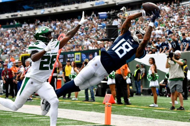 Oct 3, 2021; East Rutherford, NJ, USA;   Tennessee Titans wide receiver Josh Reynolds (18) pulls in a catch against New York Jets cornerback Brandin Echols (26) that was ruled out of bounds during the first quarter at MetLife Stadium Sunday, Oct. 3, 2021 in East Rutherford, N.J. Mandatory Credit: George Walker IV-USA TODAY Sports