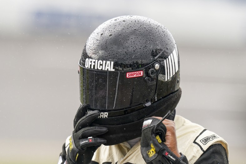 Oct 3, 2021; Talladega, Alabama, USA; NASCAR Cup Series official has rain beading up on his helmet prior to the postponing of the race  at Talladega Superspeedway. Mandatory Credit: Marvin Gentry-USA TODAY Sports