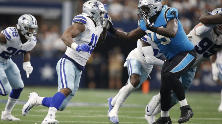 Oct 3, 2021; Arlington, Texas, USA; Dallas Cowboys linebacker Micah Parsons (11) rushes against Carolina Panthers offensive tackle Cameron Erving (75) in the fourth quarter at AT&T Stadium. Mandatory Credit: Tim Heitman-USA TODAY Sports