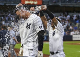 Oct 3, 2021; Bronx, New York, USA;  New York Yankees right fielder Aaron Judge (99) is doused with water after his game winning RBI single to defeat the Tampa Bay Rays 1-0 and clinch a wildcard playoff spot at Yankee Stadium. Mandatory Credit: Wendell Cruz-USA TODAY Sports