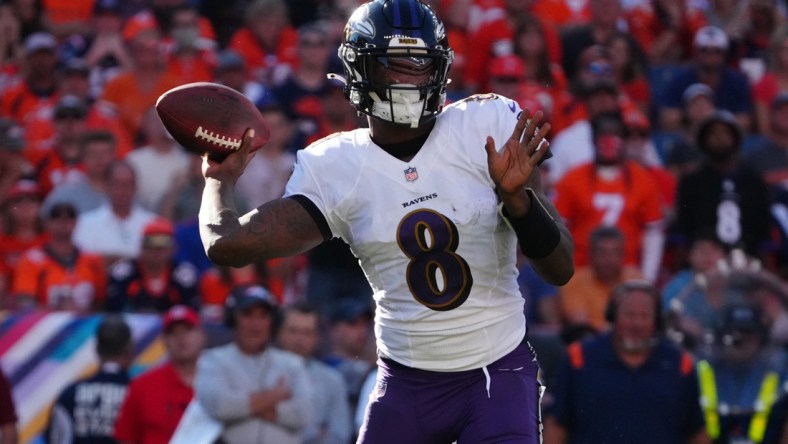 Oct 3, 2021; Denver, Colorado, USA; Baltimore Ravens quarterback Lamar Jackson (8) prepares to pass the ball in the third quarter against the Denver Broncos at Empower Field at Mile High. Mandatory Credit: Ron Chenoy-USA TODAY Sports