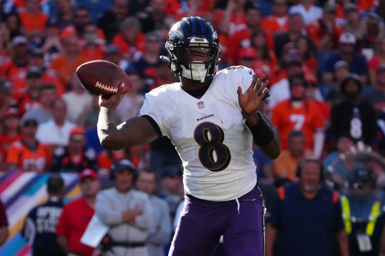 Oct 3, 2021; Denver, Colorado, USA; Baltimore Ravens quarterback Lamar Jackson (8) prepares to pass the ball in the third quarter against the Denver Broncos at Empower Field at Mile High. Mandatory Credit: Ron Chenoy-USA TODAY Sports