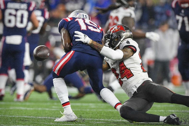 Oct 3, 2021; Foxboro, MA, USA; Tampa Bay Buccaneers cornerback Carlton Davis (24) forces the ball out against New England Patriots wide receiver Nelson Agholor (15) during the first quarter at Gillette Stadium.  Mandatory Credit: Brian Fluharty-USA TODAY Sports
