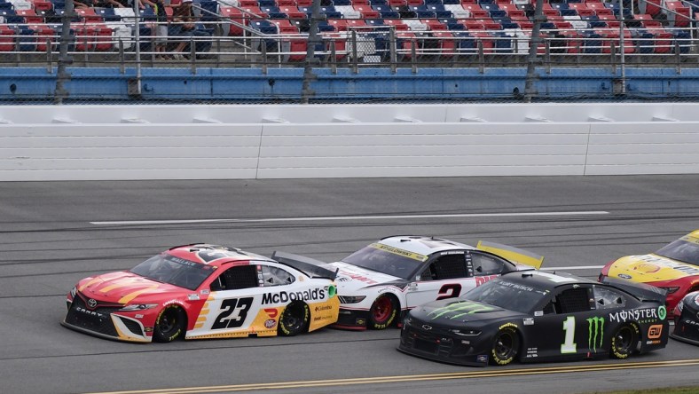 Oct 4, 2021; Talladega, Alabama, USA; NASCAR Cup Series driver Bubba Wallace (23) leads a pack of cars during the YellaWood 500 at Talladega Superspeedway. Mandatory Credit: Adam Hagy-USA TODAY Sports