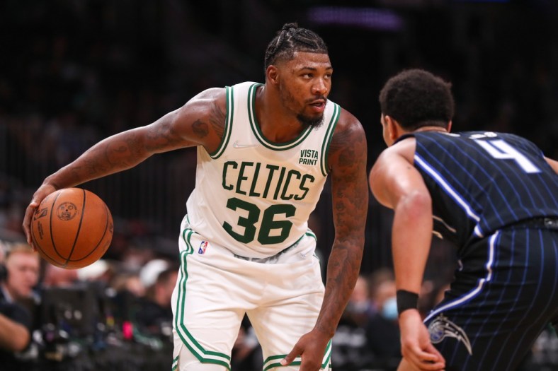 Oct 4, 2021; Boston, Massachusetts, USA; Boston Celtics guard Marcus Smart (36) controls the ball defended by Orlando Magic guard Jalen Suggs (4) during the second half at TD Garden. Mandatory Credit: Paul Rutherford-USA TODAY Sports