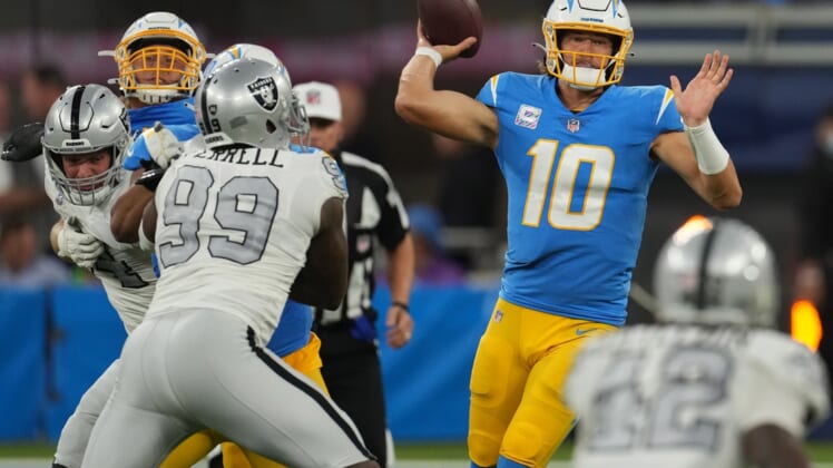 Oct 4, 2021; Inglewood, California, USA; Los Angeles Chargers quarterback Justin Herbert (10) throws a pass against the Las Vegas Raiders during the first half at SoFi Stadium. Mandatory Credit: Kirby Lee-USA TODAY Sports