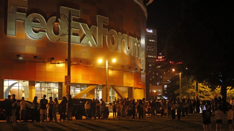 Oct 5, 2021; Memphis, Tennessee, USA; Fans wait outside of FedExForum after a fire stopped play during the third quarter of a game between the Memphis Grizzlies and the Milwaukee Bucks. Mandatory Credit: Petre Thomas-USA TODAY Sports