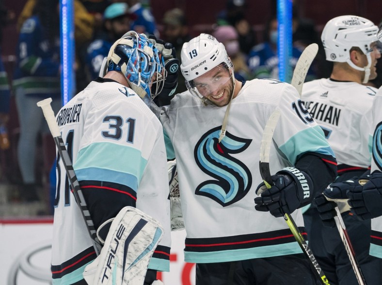 Oct 5, 2021; Vancouver, British Columbia, CAN; Seattle Kraken goalie Philipp Grubauer (31) and forward Calle Jarnkrok (19) celebrate after defeating the Vancouver Canucks at Rogers Arena. Seattle won 4-0. Mandatory Credit: Bob Frid-USA TODAY Sports