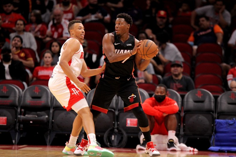 Oct 7, 2021; Houston, Texas, USA; Miami Heat guard Kyle Lowry (7) handles the ball while Houston Rockets guard Dante Exum (5) defends during the second quarter at Toyota Center. Mandatory Credit: Erik Williams-USA TODAY Sports