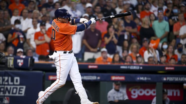 Oct 8, 2021; Houston, Texas, USA; Houston Astros first baseman Yuli Gurriel (10) hits a single and drives in two runs against the Chicago White Sox during the fifth inning in game two of the 2021 ALDS at Minute Maid Park. Mandatory Credit: Troy Taormina-USA TODAY Sports
