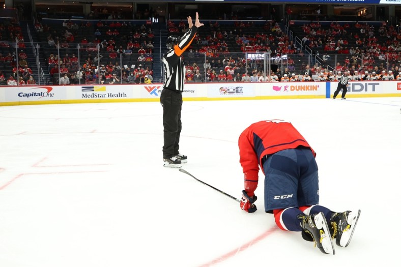Oct 8, 2021; Washington, District of Columbia, USA; Washington Capitals left wing Alex Ovechkin (8) kneels on the ice after injuring his left knee against the Philadelphia Flyers during the first period at Capital One Arena. Mandatory Credit: Geoff Burke-USA TODAY Sports