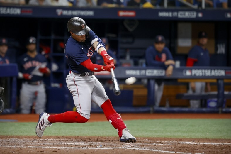 Oct 8, 2021; St. Petersburg, Florida, USA; Boston Red Sox center fielder Enrique Hernandez (5) hits a home run against the Tampa Bay Rays during the fifth inning in game two of the 2021 ALDS at Tropicana Field. Mandatory Credit: Kim Klement-USA TODAY Sports