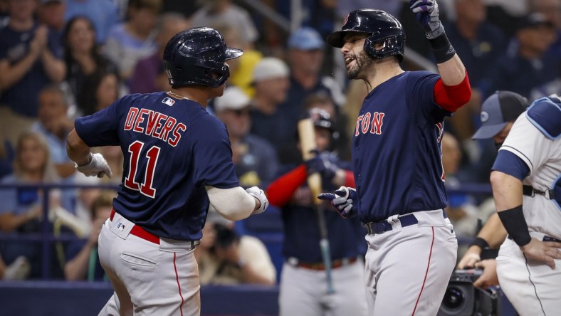 Oct 8, 2021; St. Petersburg, Florida, USA; Boston Red Sox designated hitter J.D. Martinez (28) and third baseman Rafael Devers (11) celebrate after Martinez hits a three run home run against the Tampa Bay Rays during the fifth inning in game two of the 2021 ALDS at Tropicana Field. Mandatory Credit: Kim Klement-USA TODAY Sports