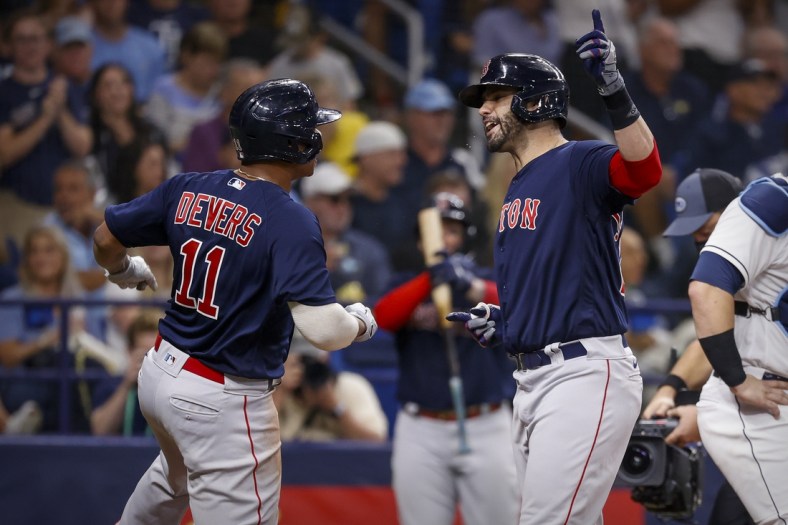 Oct 8, 2021; St. Petersburg, Florida, USA; Boston Red Sox designated hitter J.D. Martinez (28) and third baseman Rafael Devers (11) celebrate after Martinez hits a three run home run against the Tampa Bay Rays during the fifth inning in game two of the 2021 ALDS at Tropicana Field. Mandatory Credit: Kim Klement-USA TODAY Sports