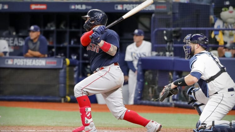 Oct 8, 2021; St. Petersburg, Florida, USA; Boston Red Sox catcher Christian Vazquez (7) hits a single and drives in a run against the Tampa Bay Rays during the seventh inning in game two of the 2021 ALDS at Tropicana Field. Mandatory Credit: Mike Watters-USA TODAY Sports