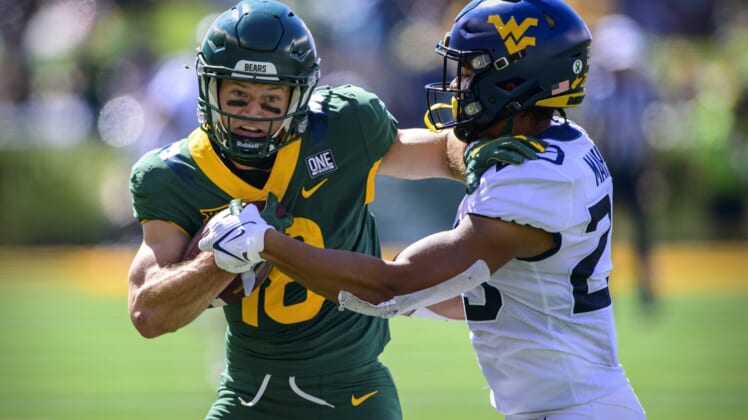 Oct 9, 2021; Waco, Texas, USA; Baylor Bears wide receiver Drew Estrada (18) stiff arms West Virginia Mountaineers safety Sean Mahone (29) during the first half at McLane Stadium. Mandatory Credit: Jerome Miron-USA TODAY Sports