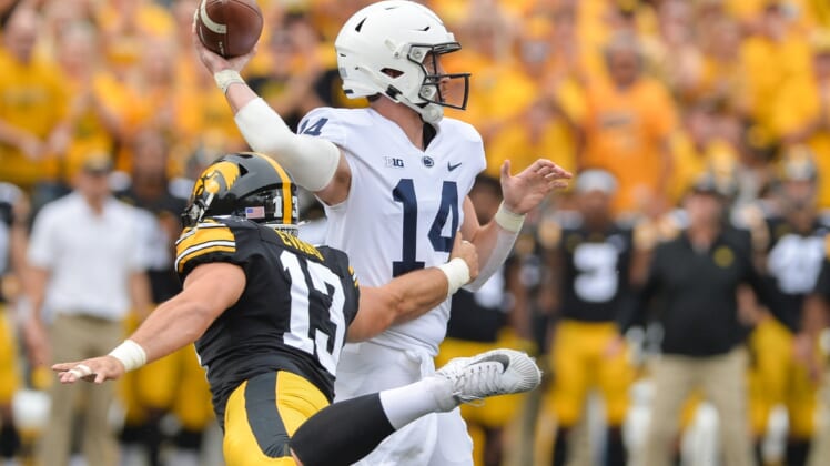 Oct 9, 2021; Iowa City, Iowa, USA; Penn State Nittany Lions quarterback Sean Clifford (14) throws a pass as Iowa Hawkeyes defensive end Joe Evans (13) rushes in during the first quarter at Kinnick Stadium. Mandatory Credit: Jeffrey Becker-USA TODAY Sports