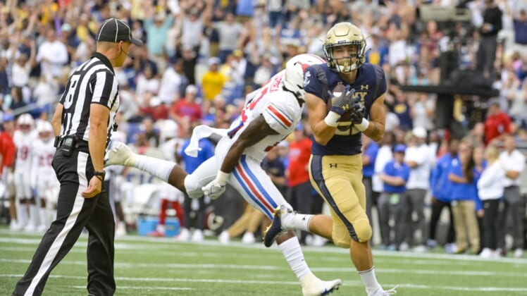 Oct 9, 2021; Annapolis, Maryland, USA;  Navy Midshipmen fullback Kai Puailoa-Rojas (21) catches a pass for a touch down as Southern Methodist Mustangs safety Isaiah Nwokobia (12) defends during the first half at Navy-Marine Corps Memorial Stadium. Mandatory Credit: Tommy Gilligan-USA TODAY Sports